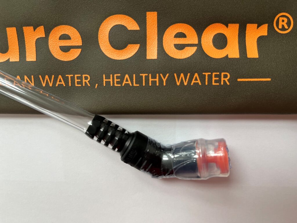 Mouthpiece and drinking tube of Pure Clear® hydration solutions against a background featuring the brand name and tagline emphasizing clean, healthy water.