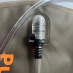Close-up of Pure Clear® 2 Litre Hydration Bladder drinking tube and bite valve, showcasing advanced seal clip and quick release features for hands-free hydration during outdoor activities.