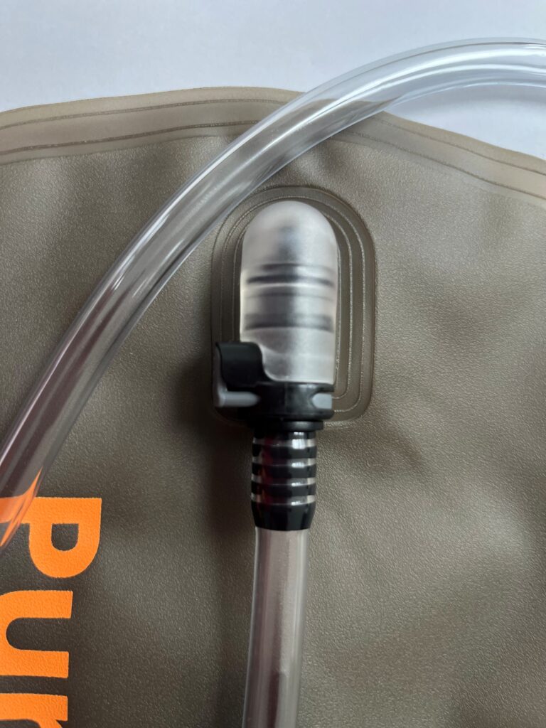 Pure Clear® 2 Litre Hydration Bladder with quick-release drinking tube and bite valve, featuring grey surface and orange branding.
