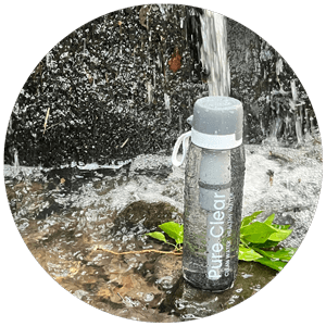 Pure Clear® active water filter bottle in a natural setting with flowing water, highlighting advanced filtration technology for outdoor activities.